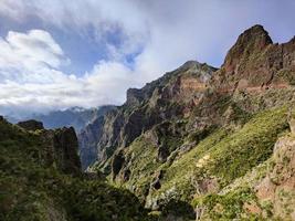 Amazing mountain view looking at the valley with passing clouds. Travel the world. Hiking in the mountains. Beautiful and inspiring nature. Relaxing and enjoyable feeling. Madeira Island, Portugal.