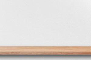 Front view of empty bookshelf and grey wall for product display or design mockup. photo