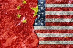 Flag of USA and China on cracked concrete wall background. Concept conflicts of two superpowers. photo