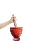 Hands holding pestle and kitchen wooden mortar isolated on white background with clipping path photo