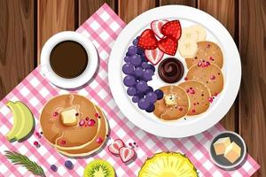 Top view food, pancake with coffee and placemat  on wood table