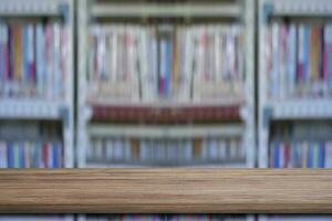 Empty wooden shelves over blurred bookshelf background. education concept. photo