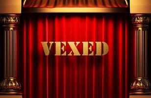 vexed golden word on red curtain photo