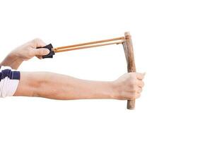 Hand holding aiming Slingshot, Isolated on white background with clipping path. photo