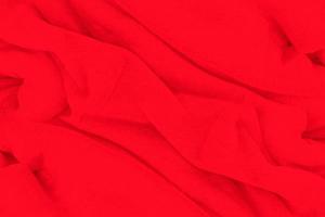fondo de textura de tela roja. telón de fondo de tela abstracta con ondas suaves. foto