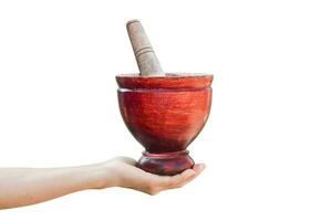 Wooden mortar and pestle in hand isolated on white background with clipping path. for use kitchen utensils.