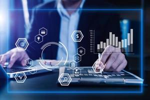 Businessman working with smart phone and laptop and digital tablet computer in  office with digital marketing media  in virtual icon photo