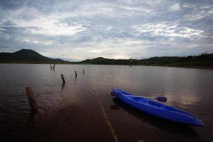 A blue boat in the morning lake photo