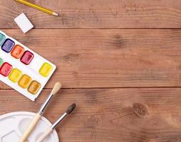 school and painter accessories  on wooden table photo