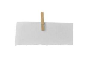 Wooden clip and white paper torn isolated on white background. Object with clipping path photo