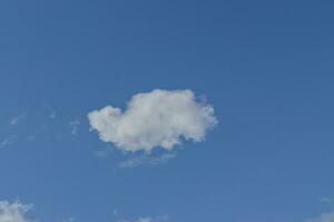 Single white cloud on blue sky background. photo