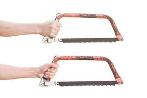 Hand holding old rusty bow saw isolated on white background with clipping path. photo