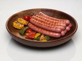 sausages in a wooden plate photo