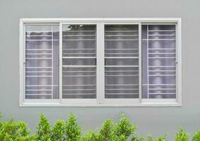 Modern windows with uv curtain and grey house wall from outside view photo