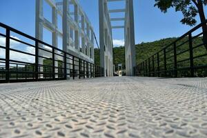 View of empty street inside the suspension bridge in thailand photo