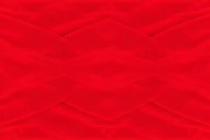 Red fabric texture background. Abstract cloth backdrop with soft waves. photo