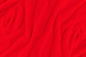 Red fabric texture background. Abstract cloth backdrop with soft waves. photo