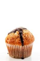 Homemade muffin with liquid chocolate on white background.Vertical image photo