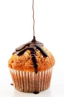 Homemade muffin with liquid chocolate on white background.Vertical image photo