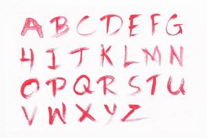 Letters A-Z with red watercolor on white paper background. Handwritten alphabet. photo