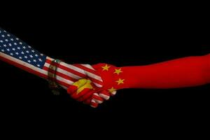 Flags written on hands USA and China. Concept revitalizing the amity usa vs china. photo