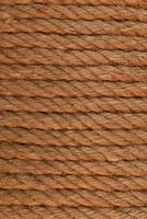 Close-up of coiled rope. Scum of the rope wrapped in rows. Texture of the fleecy rope, rows of packing twine. photo