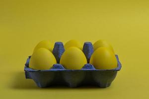 Yellow eggs on yellow background photo