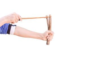 Hand holding aiming Slingshot, Isolated on white background with clipping path. photo