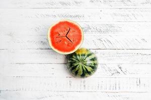 sweet fresh watermelon on white wooden background photo