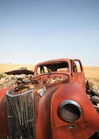 Wide angle of abandoned vehicle in scenic Saskatchewan photo