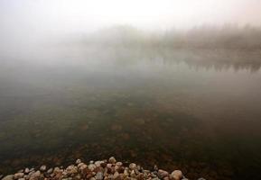 Morning fog over Waterhen River in scenic Saskatchewan photo