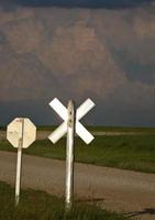 nubes de tormenta construyendo más allá de un cruce de carreteras de saskatchewan foto