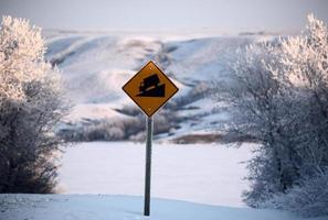 Road sign and view of Buffalo Pound Lake in winter