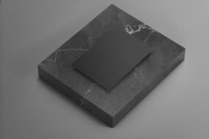 maqueta de carta de papel a4 negro sobre piedra de mármol clásico elegante foto