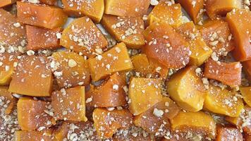 Ready to eat traditional Turkish pumpkin dessert with grated walnuts photo