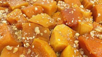 Ready to eat traditional Turkish pumpkin dessert with grated walnuts photo