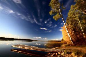 Boat dock and autumn trees along a Saskatchewan Lake photo