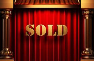 sold golden word on red curtain photo