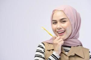 A young Muslim woman using toothbrush with beautiful teeth , Dental health care concept photo