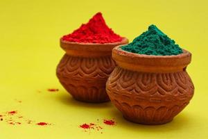 Indian festival Holi concept Multi color's bowl with colorful background. photo