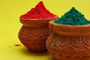 Indian festival Holi concept Multi color's bowl with colorful background. photo