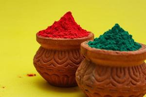 Indian festival Holi concept Multi color's bowl with colorful background. photo