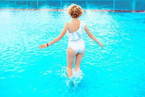 beautiful smiling redhead woman portrait enjoying life in the swimming pool in the summer day. Summer, relax, wellness, travel, recreation concept photo