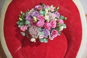 Beautiful bridal bouquet tied with silk ribbons and lace with a key in the form of heart. Roses and branches of an olive tree on the old vintage background photo