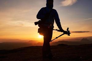 fotógrafo de naturaleza con cámara digital en la cima de la montaña. foto