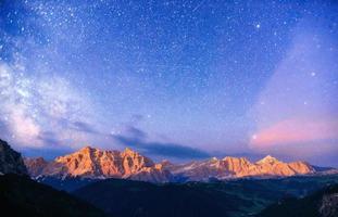 Rocky Mountains at Fantastic starry sky. Dolomite Alps, Italy photo