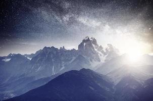 Fantastic starry sky. Autumn landscape and snow-capped peaks. Main Caucasian Ridge. Mountain View from Mount Ushba Meyer, Georgia. Europe photo