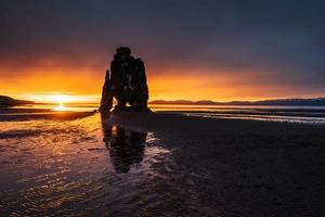 Is a spectacular rock in the sea on the Northern coast of Iceland. Legends say it is a petrified troll. On this photo Hvitserkur reflects in the sea water after the midnight sunset