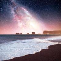 starry sky in a spectacular rock in the sea on the Northern coast of Iceland. Legends say it is a petrified troll photo