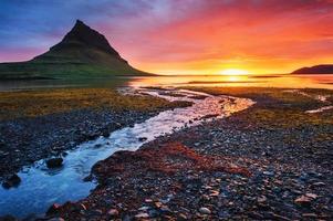 The picturesque sunset over landscapes and waterfalls. Kirkjufell mountain,Iceland photo